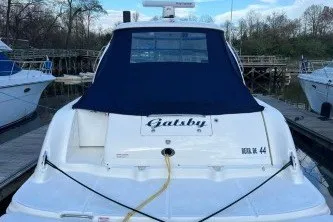 Slide: The Image of 2006 Sea Ray 44 Sundancer yacht docked, rear view with blue cover. - 2