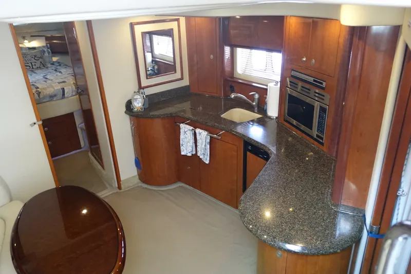 Slide: The Image of Luxurious 2006 Sea Ray 44 Sundancer yacht interior with modern kitchen and cozy bedroom. - 24
