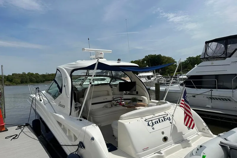 Slide: The Image of 2006 Sea Ray 44 Sundancer yacht docked, featuring a sleek design and American flag. - 5