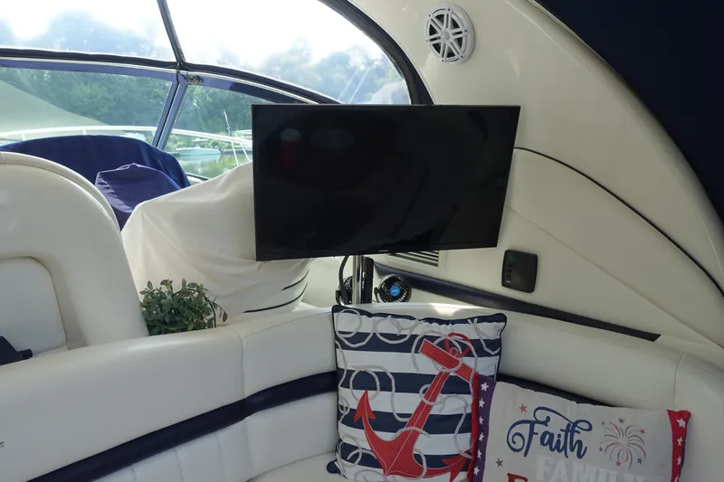 Slide: The Image of Interior of 2006 Sea Ray 44 Sundancer with TV and nautical-themed pillows. - 19