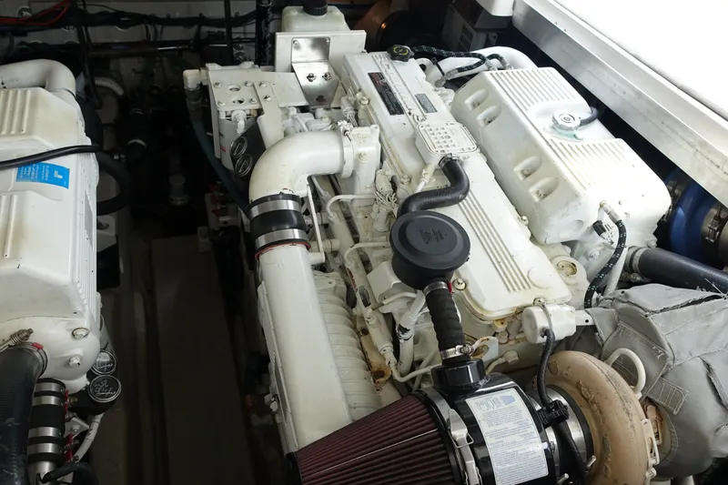 Slide: The Image of Engine room of a 2006 Sea Ray 44 Sundancer yacht, showcasing detailed machinery. - 49