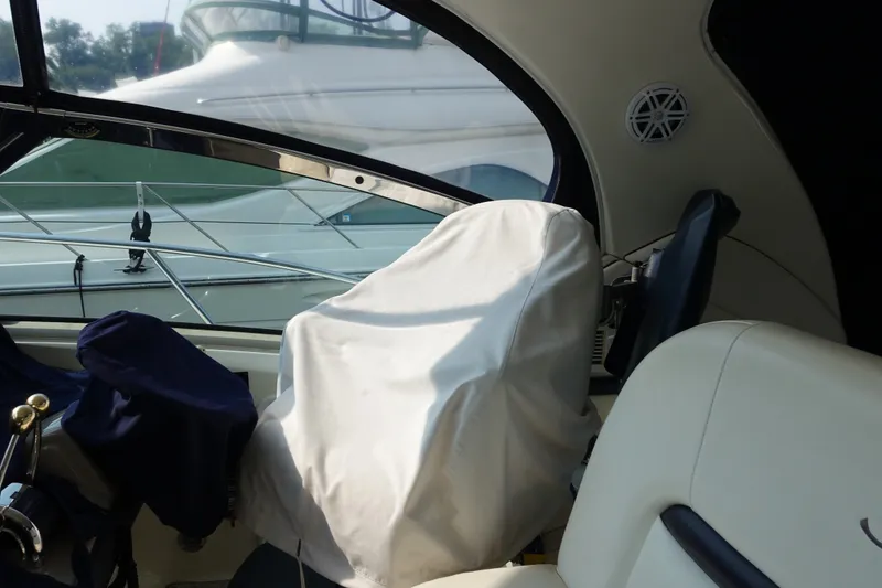 Slide: The Image of Interior view of a 2006 Sea Ray 44 Sundancer yacht cockpit with covered controls. - 51