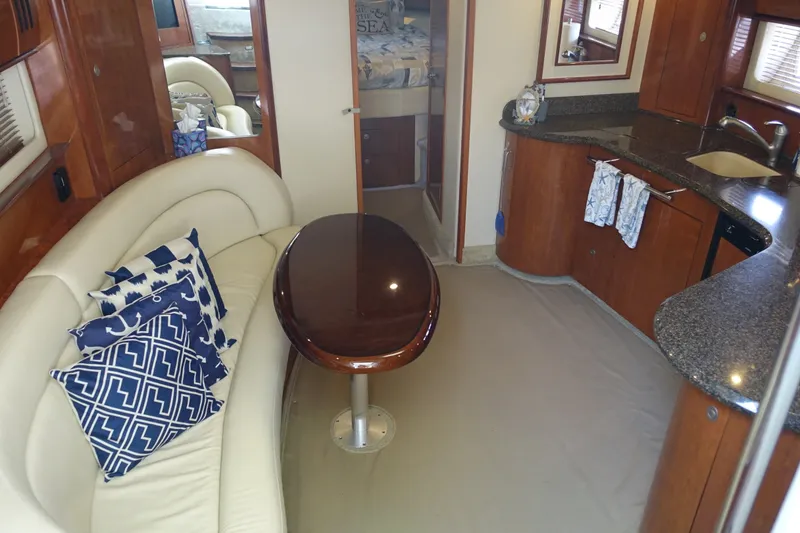 Slide: The Image of Interior of 2006 Sea Ray 44 Sundancer yacht with elegant seating and kitchen area. - 23