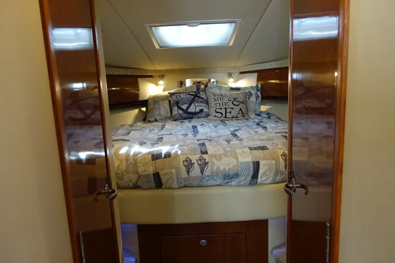 Slide: The Image of Luxurious cabin interior of 2006 Sea Ray 44 Sundancer yacht with nautical-themed bedding. - 38