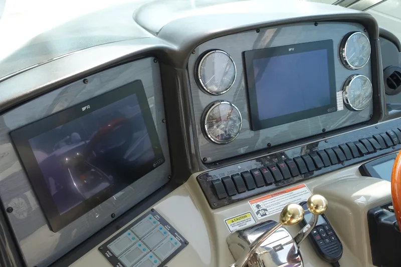 Slide: The Image of The image shows the dashboard of a 2006 Sea Ray 44 Sundancer with modern instruments. - 8