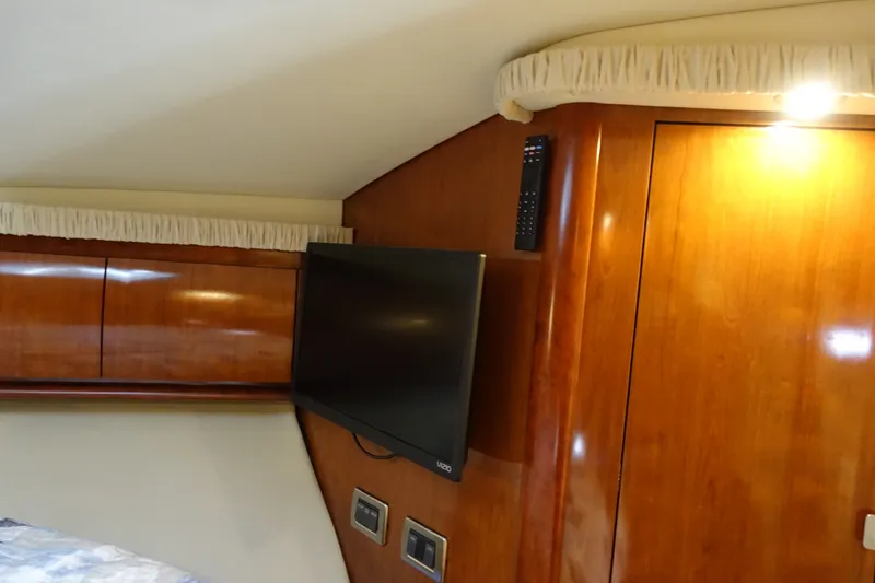 Slide: The Image of Interior of 2006 Sea Ray 44 Sundancer with wood paneling and mounted TV. - 41