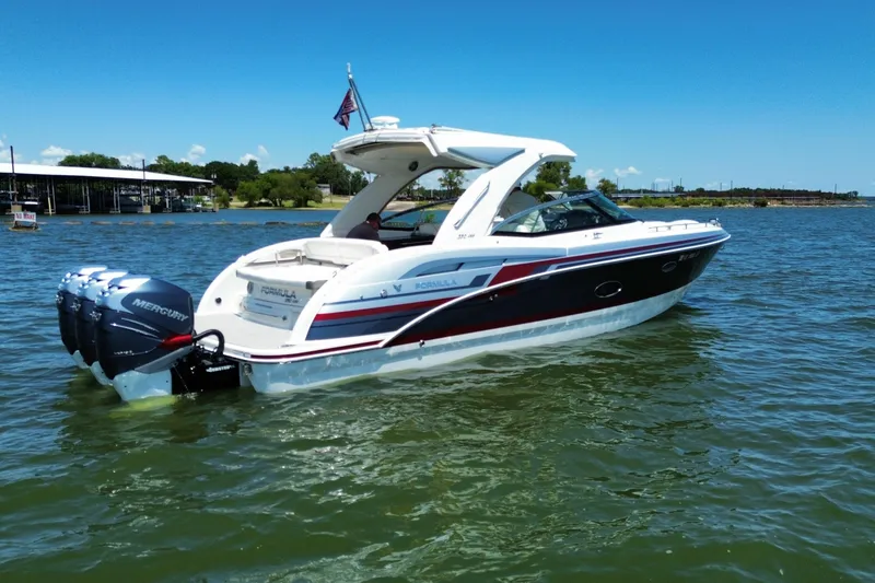 Slide: The Image of 2020 Formula 350 Crossover Bowrider OB on a sunny lake, featuring triple Mercury outboards. - 51