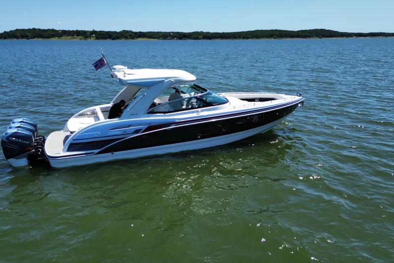 Slide: The Image of 2020 Formula 350 Crossover Bowrider OB cruising on a sunny lake. - 9