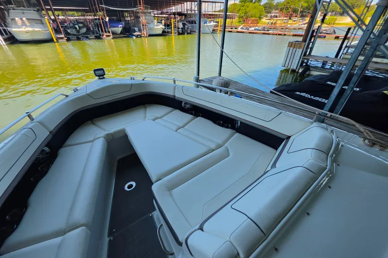Slide: The Image of 2020 Formula 350 Crossover Bowrider OB with spacious seating at a marina dock. - 32