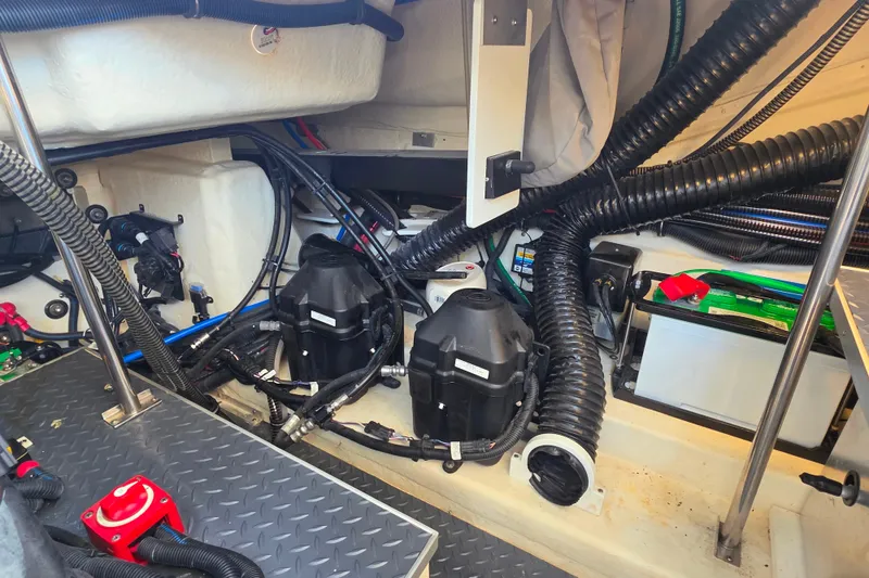 Slide: The Image of Engine compartment of a 2020 Formula 350 Crossover Bowrider OB with visible wiring and components. - 44
