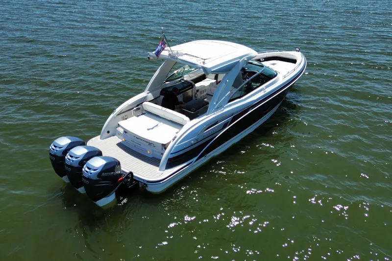Slide: The Image of 2020 Formula 350 Crossover Bowrider OB on open water, featuring triple Mercury outboards. - 6