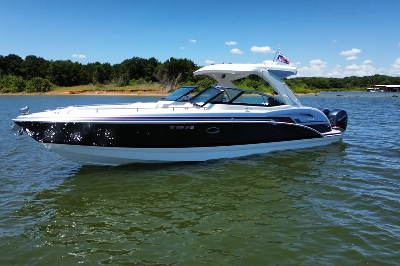 Slide: The Image of 2020 Formula 350 Crossover Bowrider OB on a sunny lake, surrounded by trees. - 54