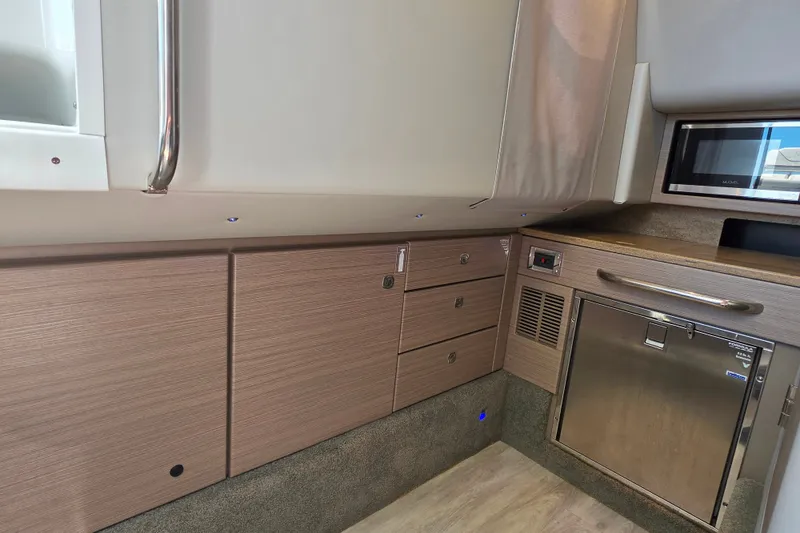 Slide: The Image of 2020 Formula 350 Crossover Bowrider OB interior with modern cabinetry and stainless steel appliances. - 38