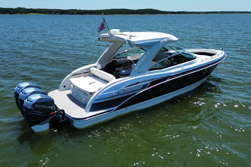 Slide: The Image of 2020 Formula 350 Crossover Bowrider OB on a serene lake, showcasing sleek design and triple Mercury engines. - 8