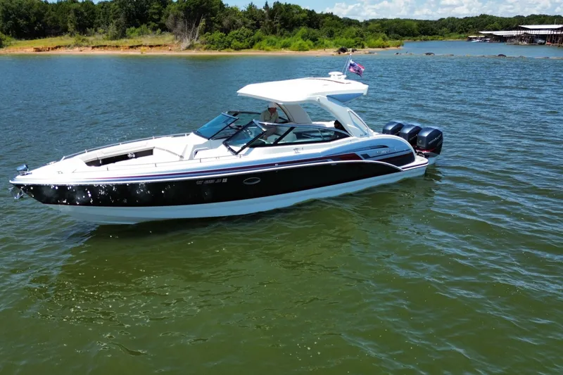 Slide: The Image of 2020 Formula 350 Crossover Bowrider OB on a serene lake with lush shoreline. - 56