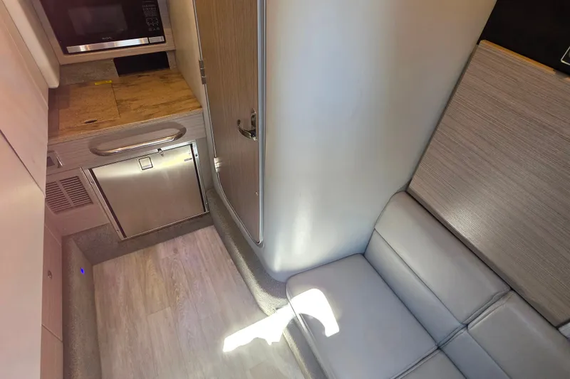 Slide: The Image of 2020 Formula 350 Crossover Bowrider OB interior with kitchenette and seating area. - 33