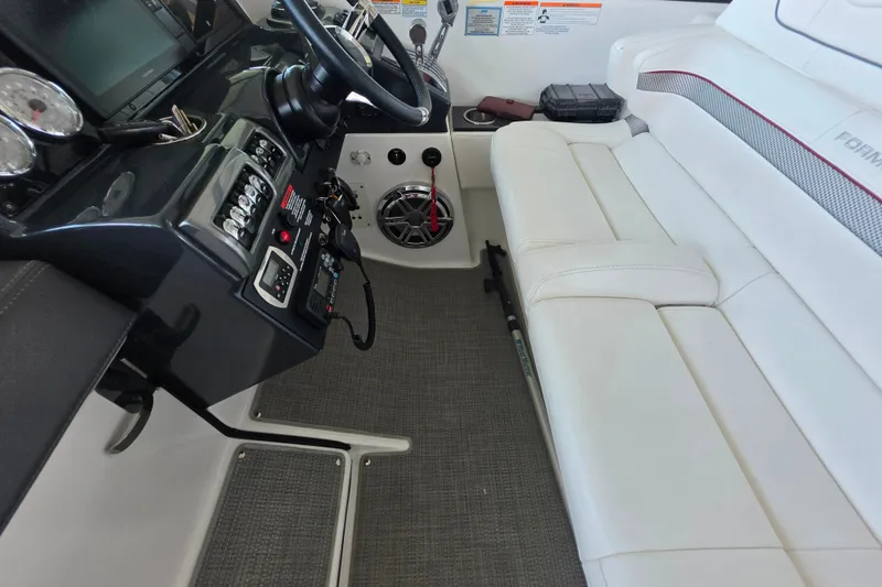 Slide: The Image of Interior of 2020 Formula 350 Crossover Bowrider OB, featuring helm and white seating. - 28