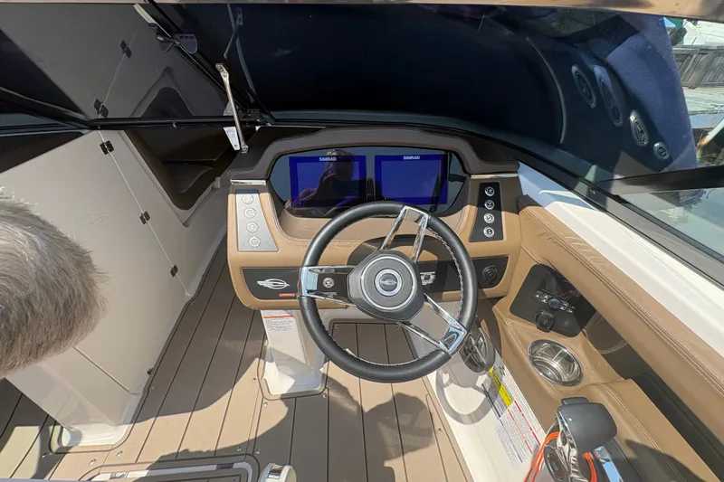 Slide: The Image of 2024 Chaparral 247 SSX boat cockpit with modern steering and navigation displays. - 9