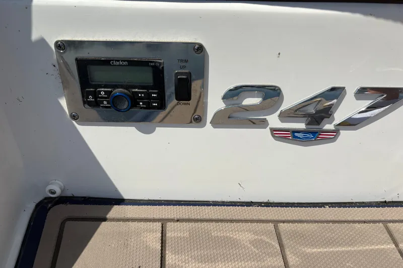 Slide: The Image of 2024 Chaparral 247 SSX boat dashboard with Clarion audio system and trim controls. - 24