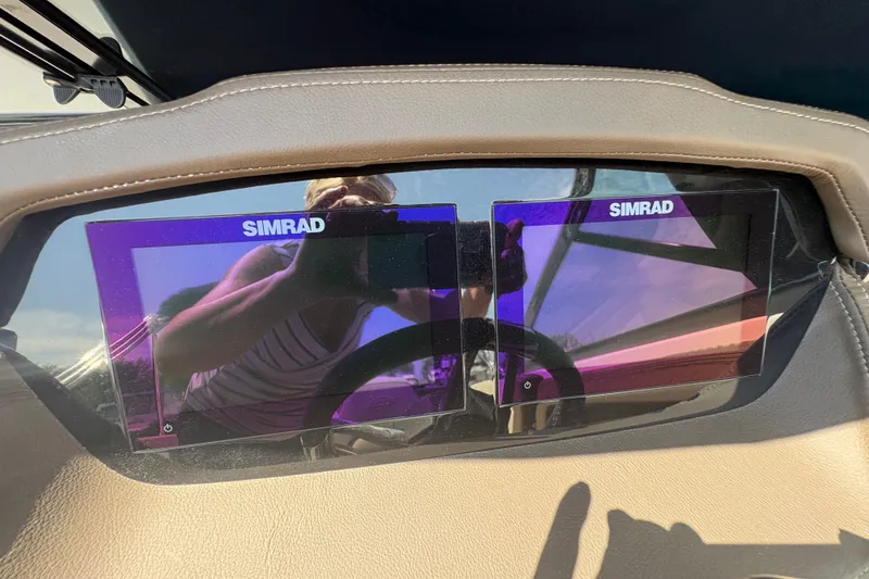 Slide: The Image of 2024 Chaparral 247 SSX dashboard featuring dual Simrad displays. - 11