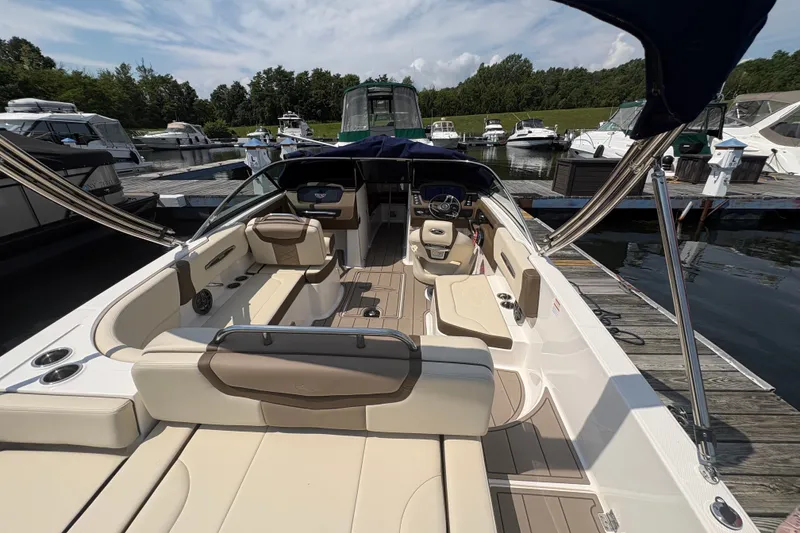 Slide: The Image of 2024 Chaparral 247 SSX boat interior at marina, featuring luxurious seating and modern design. - 21