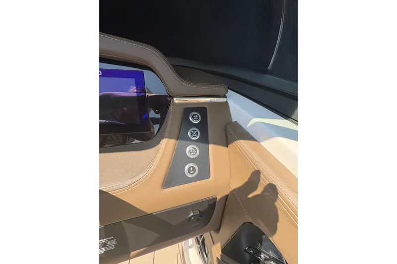 Slide: The Image of 2024 Chaparral 247 SSX dashboard with control buttons and touchscreen display. - 12