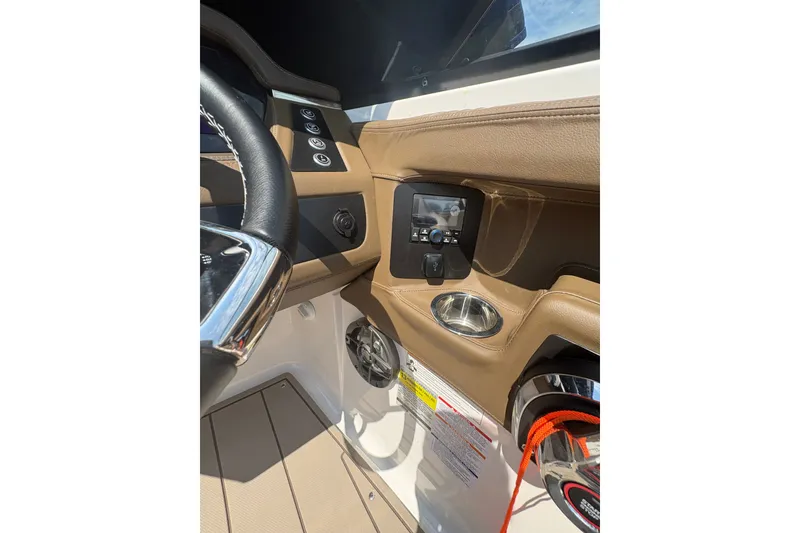 Slide: The Image of 2024 Chaparral 247 SSX boat dashboard with steering wheel and control panel. - 13