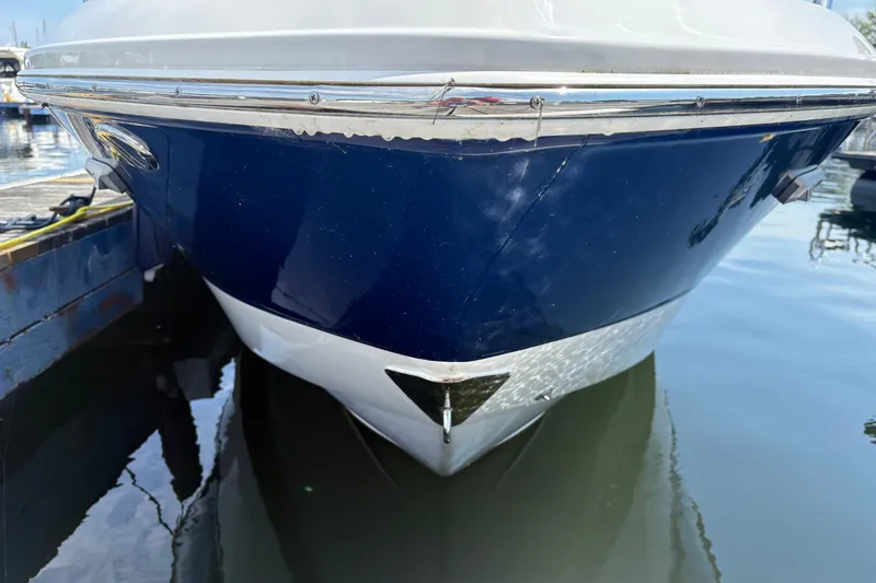 Slide: The Image of 2024 Chaparral 247 SSX boat docked, showcasing sleek blue and white hull design. - 3