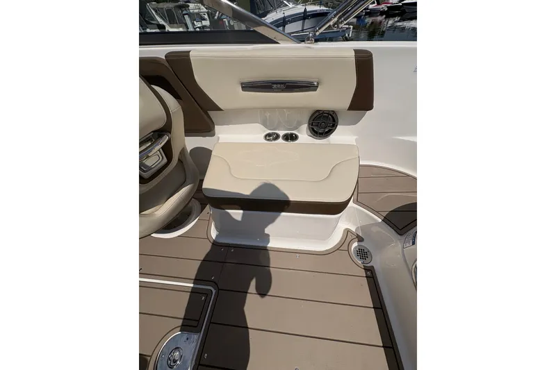 Slide: The Image of 2024 Chaparral 247 SSX boat interior with beige seating and brown accents. - 16
