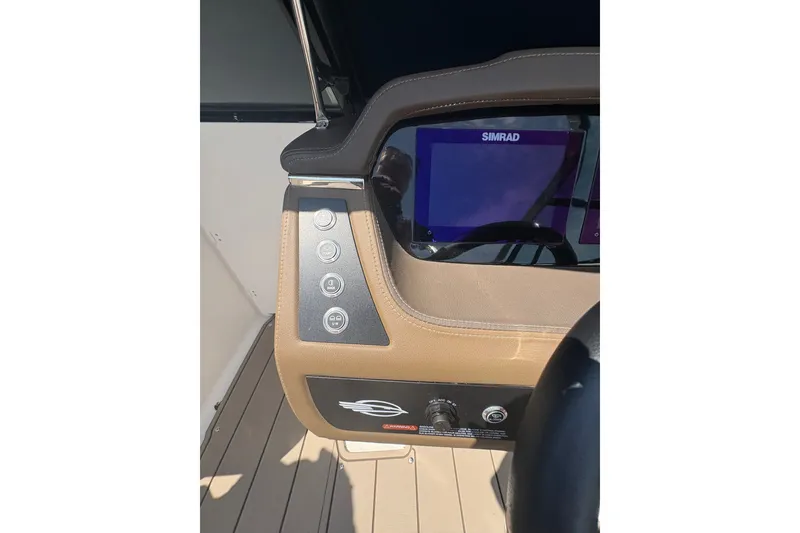 Slide: The Image of 2024 Chaparral 247 SSX dashboard with Simrad display and control panel. - 10