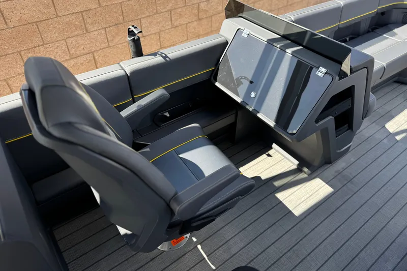 Slide: The Image of Interior of 2025 Manitou EXPLORE 24 boat with modern seating and dashboard. - 22