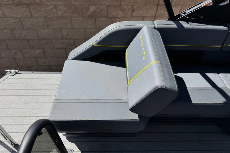 Slide: The Image of 2025 Manitou EXPLORE 24 boat seat with sleek gray upholstery and yellow accents. - 20