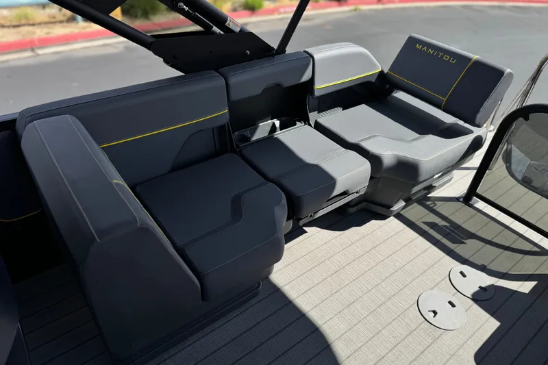 Slide: The Image of 2025 Manitou EXPLORE 24 boat seating area with modern design and comfortable upholstery. - 15