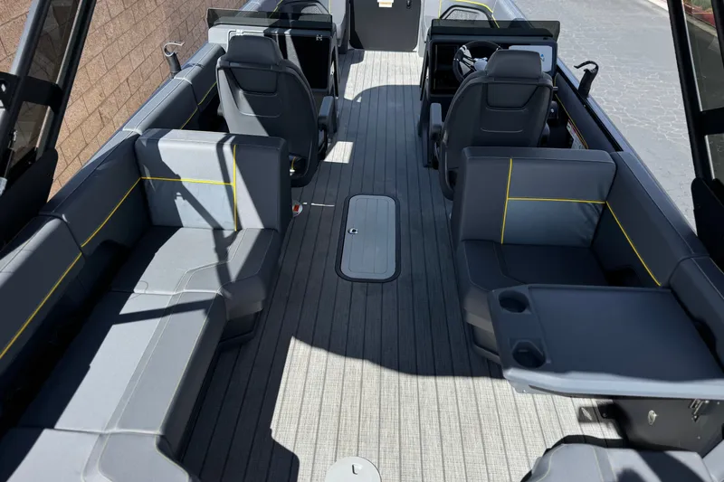 Slide: The Image of Interior of 2025 Manitou EXPLORE 24 boat with modern seating and sleek design. - 21