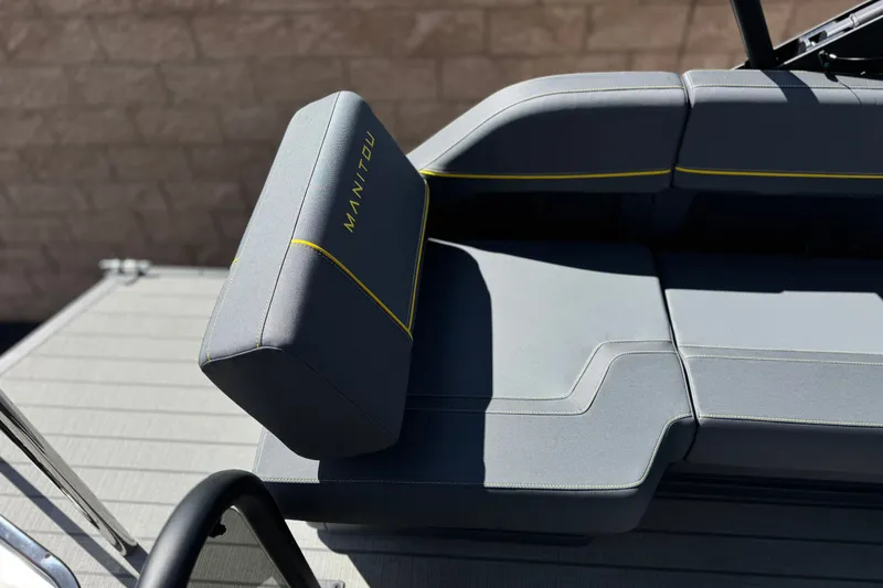 Slide: The Image of 2025 Manitou EXPLORE 24 boat seating with sleek gray upholstery and yellow accents. - 19