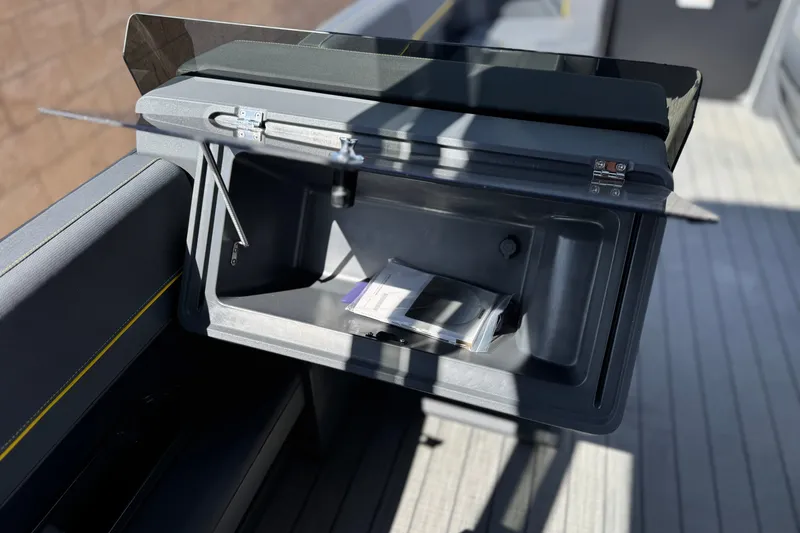 Slide: The Image of Storage compartment on 2025 Manitou EXPLORE 24 boat, showcasing sleek design and functionality. - 23