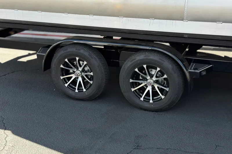 Slide: The Image of Trailer wheels of a 2025 Manitou EXPLORE 24 on asphalt surface. - 28