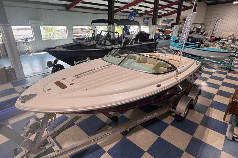 Slide: The Image of 2005 Chris Craft Speedster boat displayed indoors on a trailer. - 13