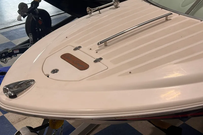 Slide: The Image of 2005 Chris Craft Speedster boat bow with chrome details and sleek design. - 15