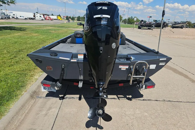Slide: The Image of 2023 Ranger RT178 boat with Mercury 75 engine, parked on a sunny day. - 2