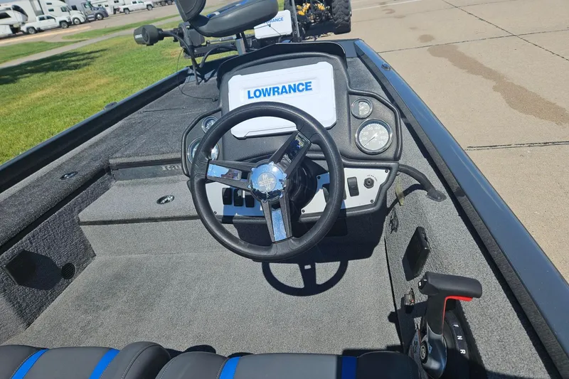 Slide: The Image of 2023 Ranger RT178 boat dashboard with steering wheel and Lowrance display. - 1