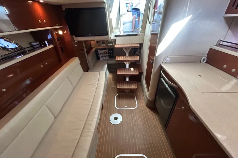 Slide: The Image of Interior of 2008 Sea Ray Sundancer 330 yacht with modern amenities and wooden flooring. - 16