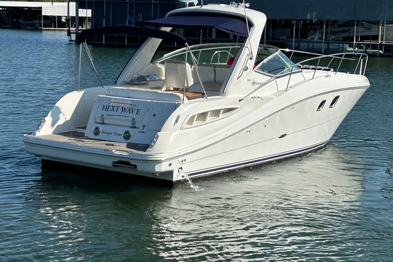 Slide: The Image of 2008 Sea Ray Sundancer 330 yacht on water, featuring sleek design and spacious deck. - 3