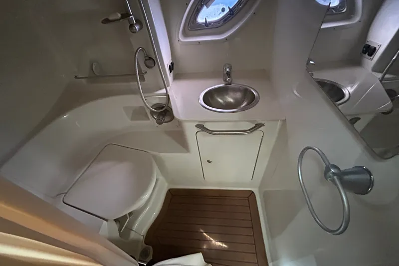 Slide: The Image of 2008 Sea Ray Sundancer 330 bathroom with sink, toilet, and shower in compact layout. - 15
