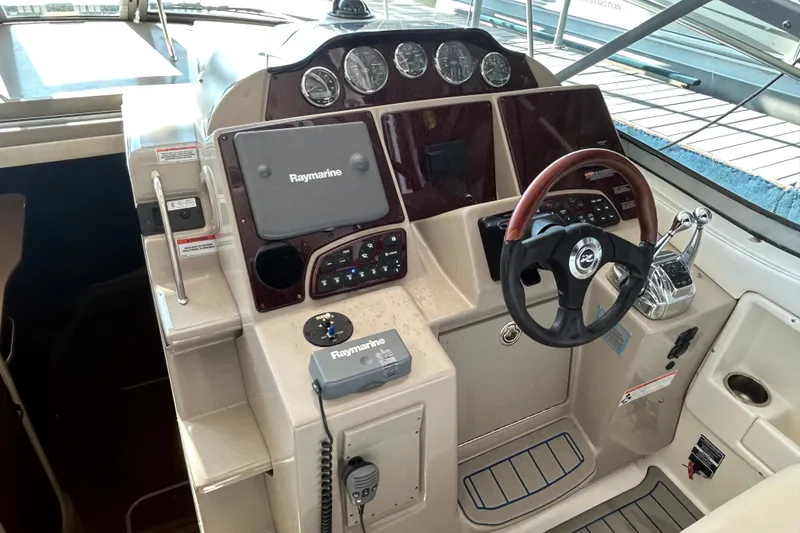 Slide: The Image of 2008 Sea Ray Sundancer 330 helm with Raymarine navigation system and wood-accented steering wheel. - 19