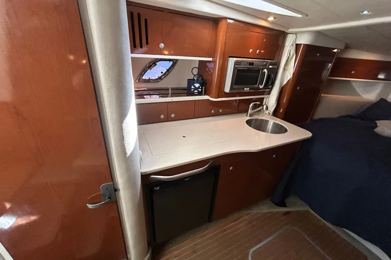 Slide: The Image of Interior of 2008 Sea Ray Sundancer 330 yacht with kitchenette and wood cabinetry. - 9