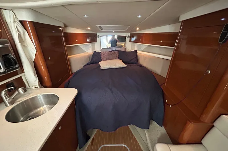 Slide: The Image of Luxurious interior of 2008 Sea Ray Sundancer 330 with cozy bed and kitchenette. - 32