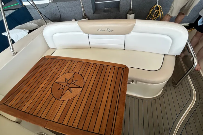 Slide: The Image of 2008 Sea Ray Sundancer 330 interior with wooden table and cushioned seating. - 28