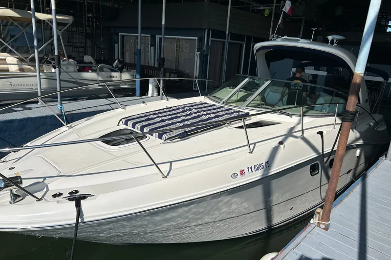 Slide: The Image of 2008 Sea Ray Sundancer 330 docked, featuring sleek design and spacious deck. - 23