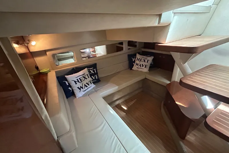 Slide: The Image of Interior of 2008 Sea Ray Sundancer 330 with cozy seating and nautical-themed pillows. - 13